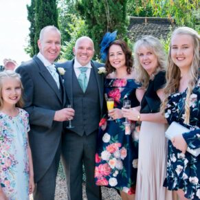 Notley Tythe Barn wedding guests pose for the camera on the terrace