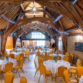 Notley Tythe Barn wedding venue interior all prepared for the meal