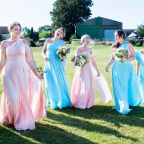 Bridesmaids take a stroll at Notley Tythe Barn wedding reception