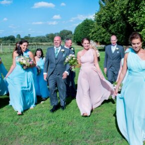 Notley Tythe Barn wedding party takes a walk through the gardens
