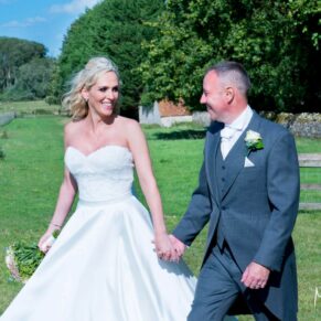 The newlyweds go for a walk at their Notley Tythe Barn wedding