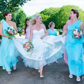 The ladies go for a stroll through the grounds at Notley Tythe Barn wedding