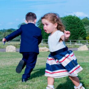 Notley Tythe Barn wedding children chasing around the gardens