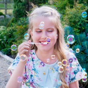 Notley Tythe Barn wedding bubbles being blown by this young guest