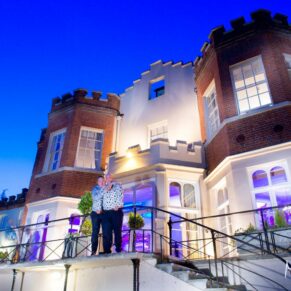 Same sex gay Buckinghamshire wedding photography on the terrace at Taplow House for a night-time photo