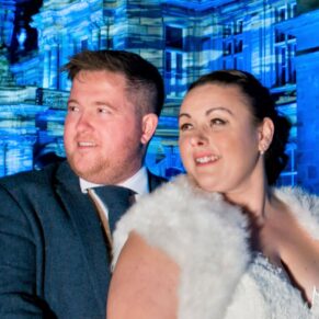 Waddesdon Dairy winter wedding photograph of the newlyweds at the manor with the Christmas illuminations