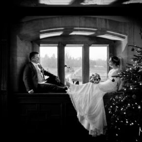 Buckinghamshire black & white wedding photography - the newlyweds sat in the window