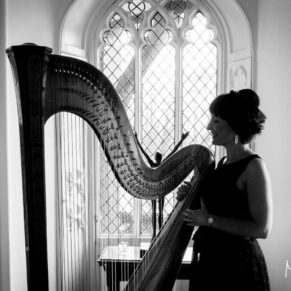 Buckinghamshire black and white wedding photography of the harpist in silhouette