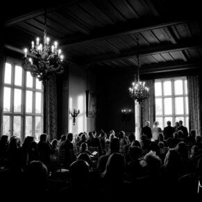 Dramatic lighting in the Red Room at Eynsham Hall Christmas wedding