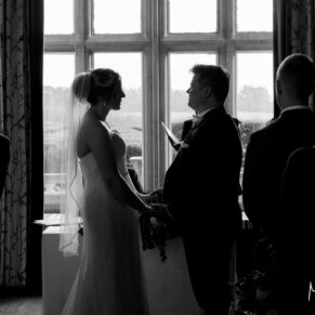 The civil ceremony in progress at Eynsham Hall Christmas wedding