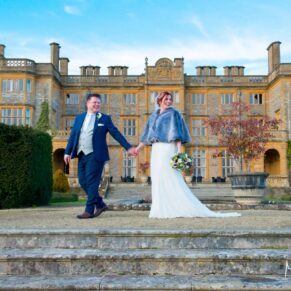 The couple take a stroll at their Eynsham Hall Christmas wedding