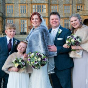 Eynsham Hall Christmas wedding group pose in the chilly gardens