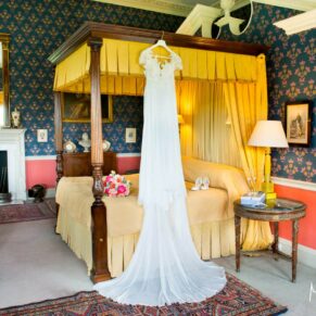 Hartwell House wedding photographs of the gown hanging from the four poster bed