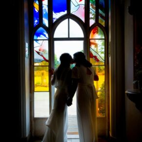 Missenden Abbey wedding kiss in the arched window