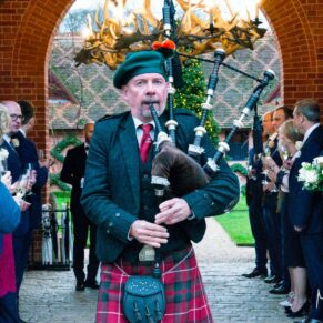 Waddesdon Dairy winter wedding photography of the bagpipe player
