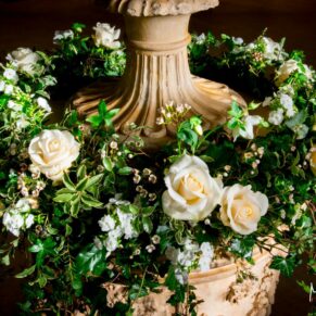 Waddesdon Dairy winter wedding photography of a stunning floral arrangement on the Roman urn