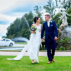 Cliveden House wedding photographs of the newlyweds strolling beside the fountain