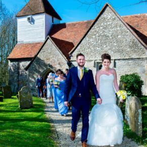 The newlyweds leaving the chapel at their Dorton House wedding