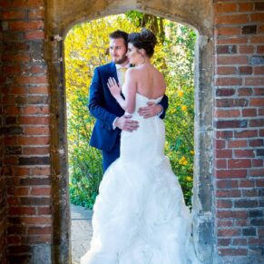 The newlyweds through the archway at Dorton House wedding