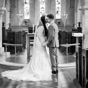 The first kiss - St Giles Church wedding - Standlake