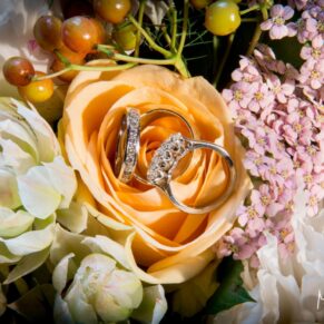 Eynsham Hall wedding photographs of rings on rose