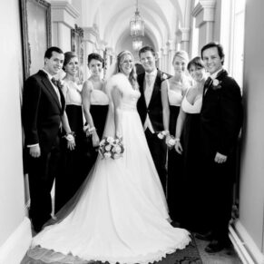 Group pose in the Gothic Passage at Hampden House Christmas wedding