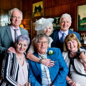 Relaxed group pose in the bar at Hartwell House Hotel wedding