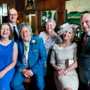 Group pose in the bar at Hartwell House Hotel wedding