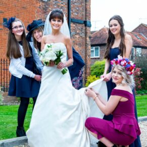 Kings Chapel Amersham wedding photographs of the bride's dress being arranged