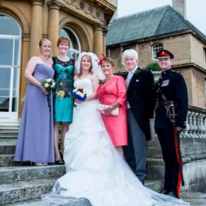 Group pose on the steps at Halton House wedding