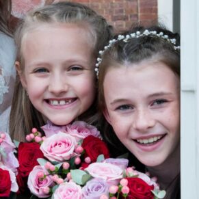 Photography of the bridesmaids giggling away as they look out from the carriage at this Sopwell House summer wedding