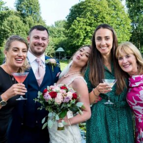 A relaxed photography capture of the bride and groom with a couple of their friends in the gardens of their Sopwell House wedding