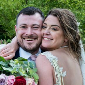 Photography of the happy bride and groom enjoying a loving embrace at their Sopwell House wedding reception