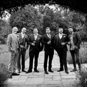 Photography of the lads framed perfectly through an archway in the gardens of this Sopwell House wedding