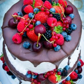Photography of scrumptious and colourful chocolate cake for the guests to enjoy at this Bay Tree Hotel wedding in Burford