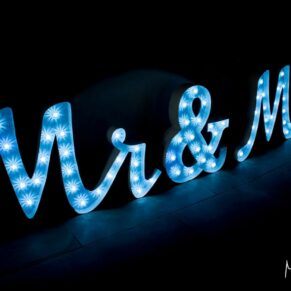 Photography of Mr and Mrs giant illuminated letters captured on the dance-floor at at this Bay Tree Hotel wedding in Burford