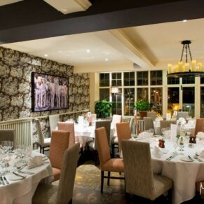Photography of the stylish and atmospheric interiors all setup for the wedding breakfast at the Bay Tree Hotel in Burford