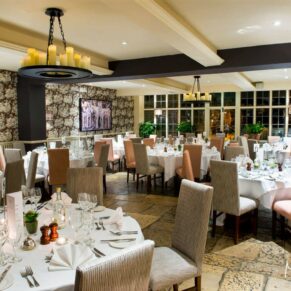 Photography of the atmospheric dining room wedding setup pre meal inside the historic Bay Tree Hotel in Burford