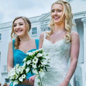 Smiling ladies taking a stroll during the drinks reception in front of the White House at this Beaumont Estate summer wedding
