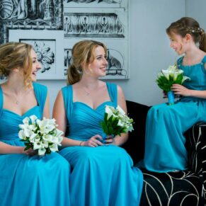 The bridesmaids chatting before the ceremony in the grand entrance area at this Beaumont Estate wedding