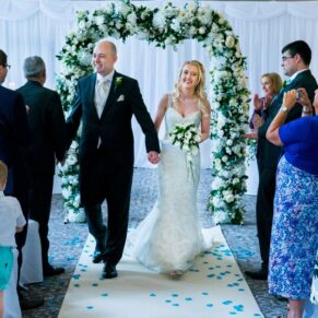 The happy newlyweds exit their civil wedding ceremony watched by their nearest and dearest at their Beaumont Estate wedding