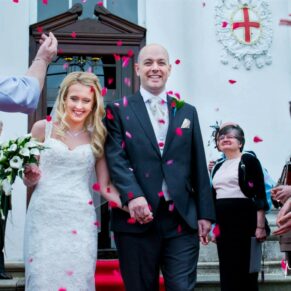 The happy newlyweds walk through their colourful confetti aisle outside the the White House at their Beaumont Estate wedding
