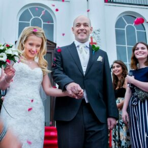 The smiling newlyweds dash through their confetti aisle in front of the White House at their Beaumont Estate wedding