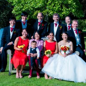 Natural wedding group pose of the bridal party at this summer wedding celebration at Bisham Abbey