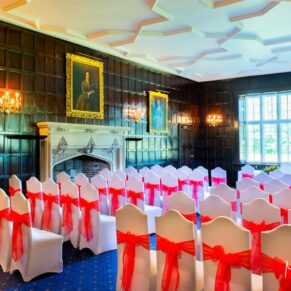 Ceremony room setup up with a really vibrant colour scheme for this Bisham Abbey wedding
