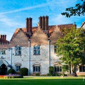 The front of the historic Bisham Abbey under near perfect blue skies