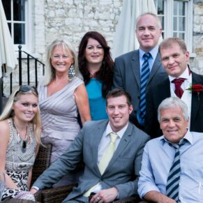 Casual group pose of seven friends captured during the drinks reception