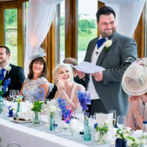 The groom's lively speech in progress with fabulous reactions from his family sat at the top table
