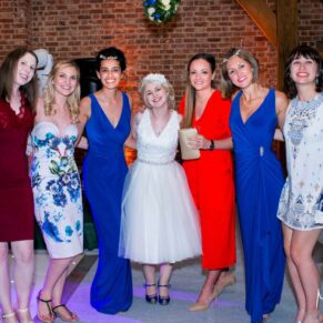 The bride with her girlfriends on the dancefloor during the evening reception