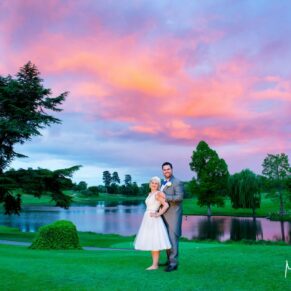 Photography of the newlyweds placed in front of the stunning sunset with fabulous distant views across the lake and beyond at their Brocket Hall wedding